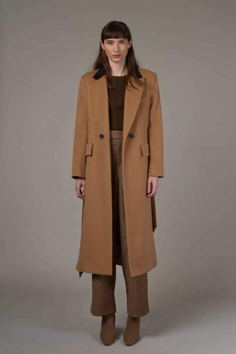 Tailored camel and black wool coat with a double-breasted front, welt pockets, and a colorblock collar.